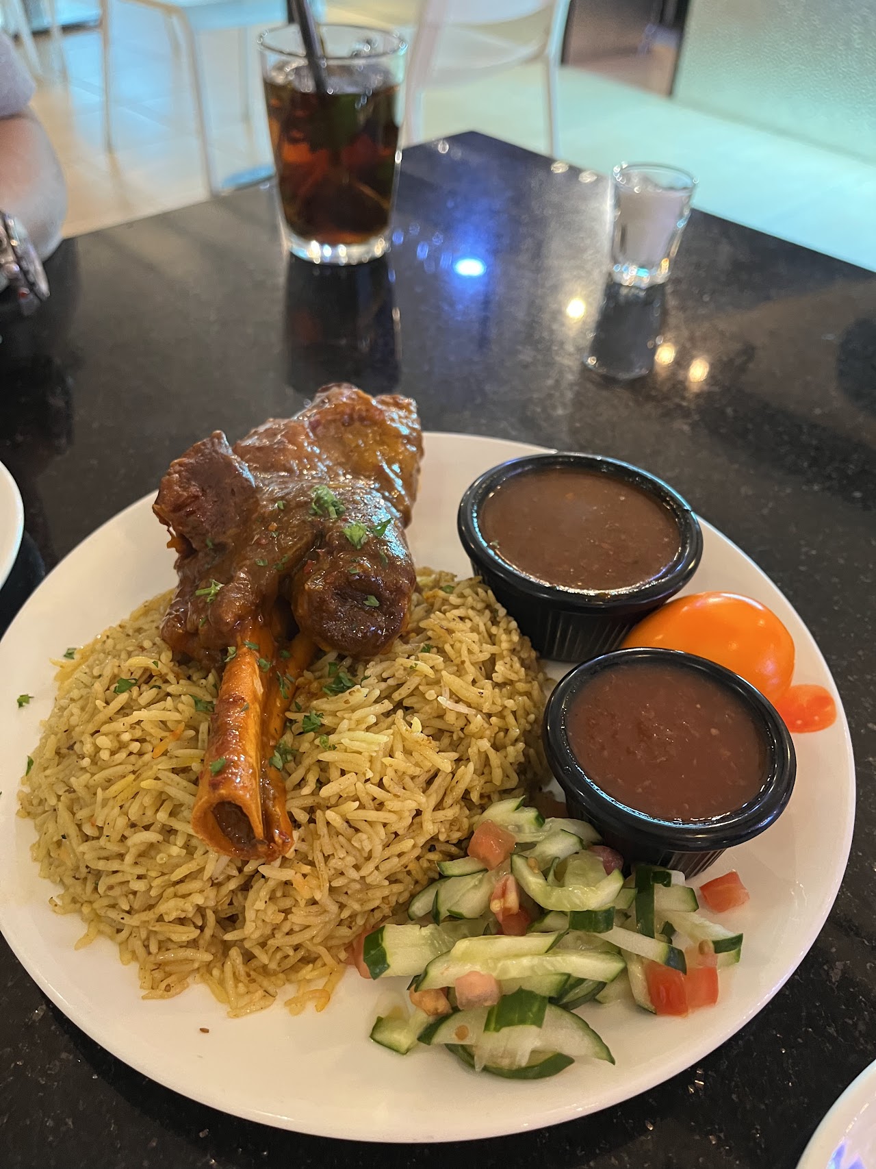 Lamb shank with rice and Arabic sides at Chef Ammar