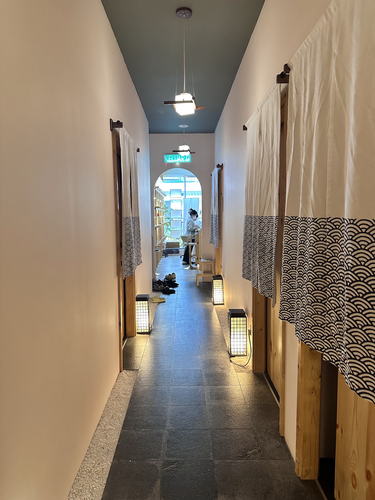 Face Bar Bukit Jalil treatment room corridor with seigaiha-print noren curtains and paper lanterns