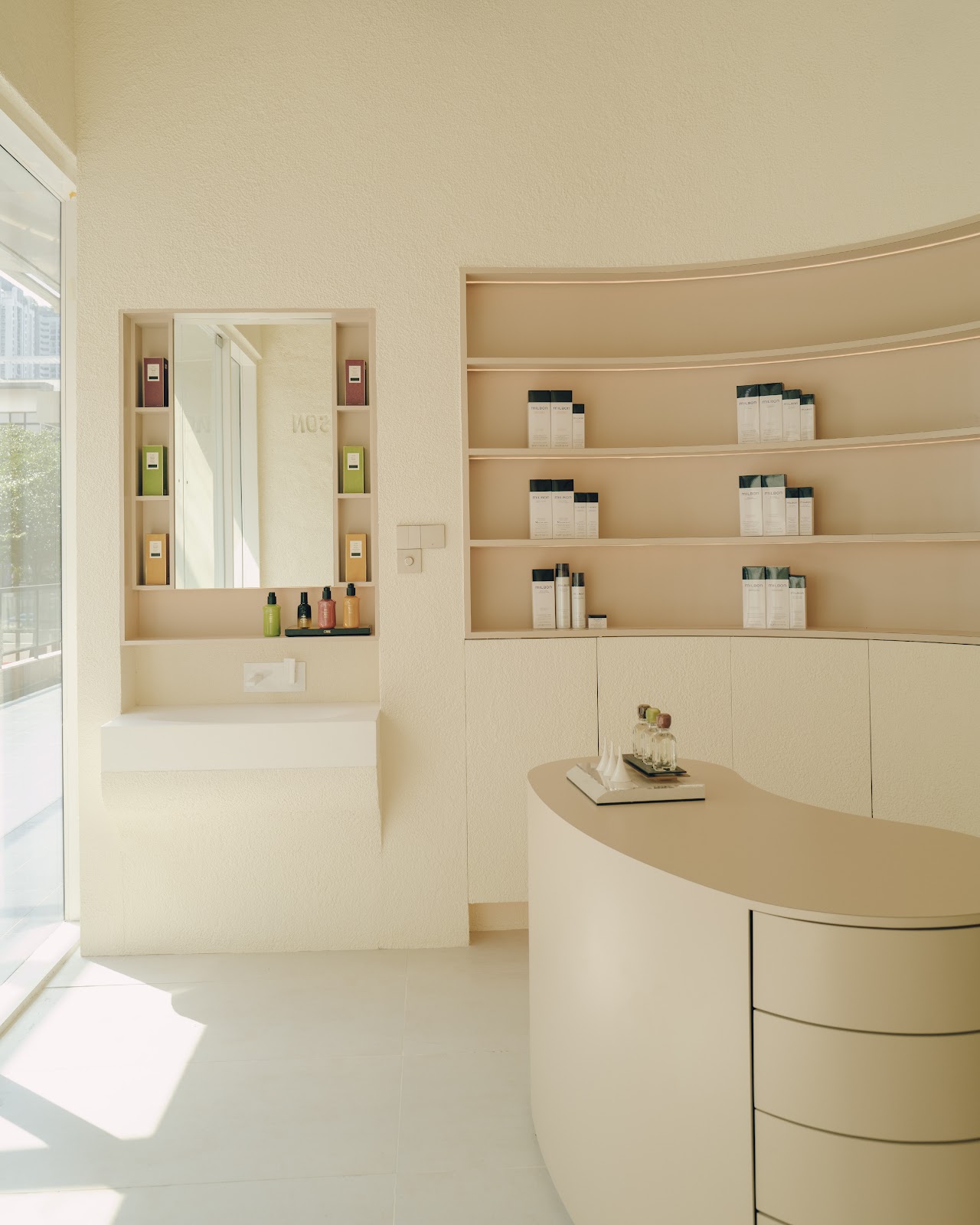 Sculptural curved reception counter at Her Maison Bukit Jalil