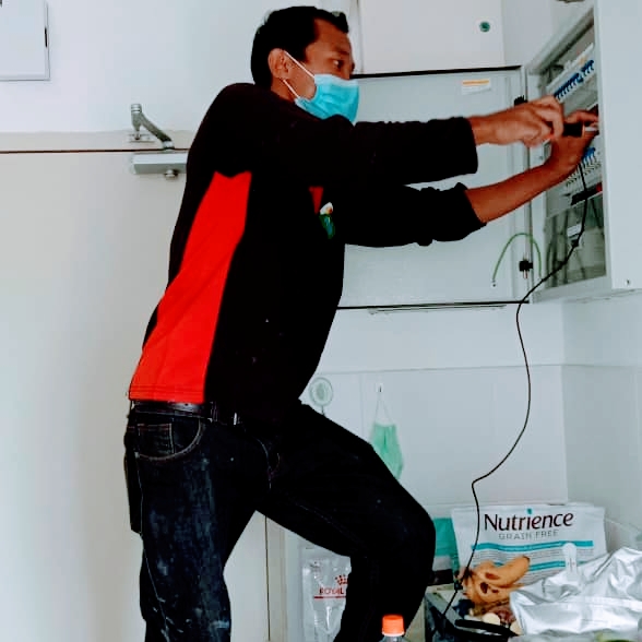 Technician working on distribution panel