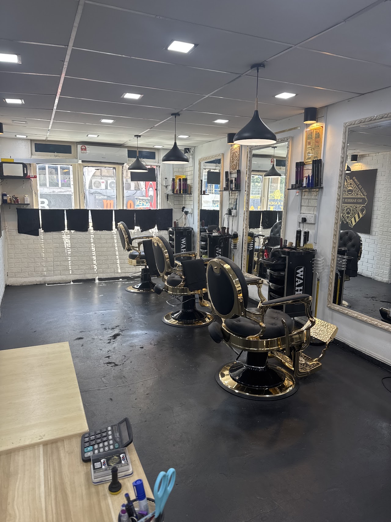 Gold-trimmed vintage barber chairs at MD Hilmi Barber Shop