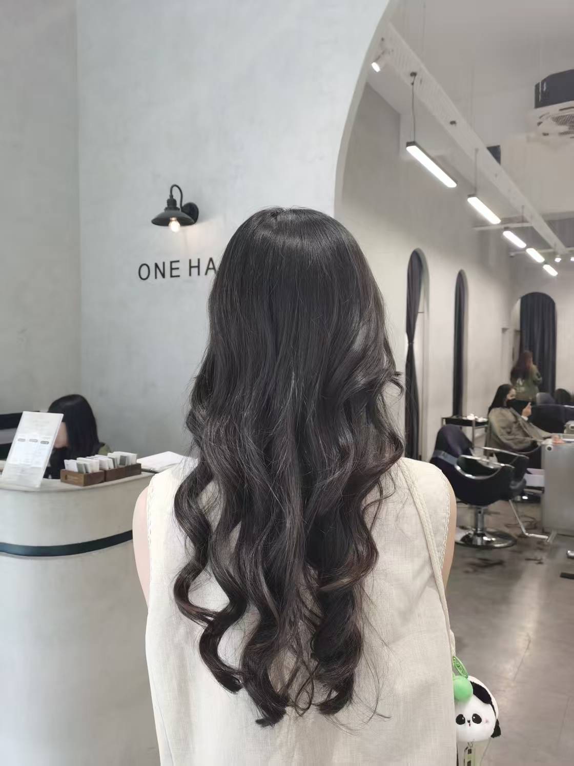 ONE HAIR salon interior with finished wavy style