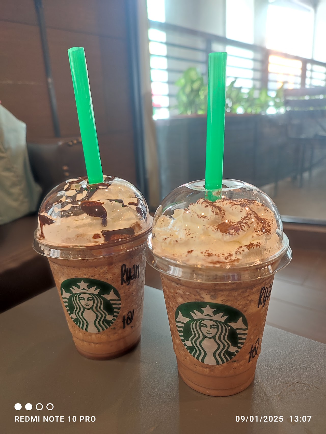 Two iced frappuccinos with green straws at Starbucks USJ Taipan